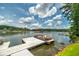 A pontoon boat waits at the dock on a sunny day with puffy white clouds at 590 Yancey Cir, Covington, GA 30014