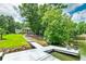 View from the dock looking toward the house with lush green grass at 590 Yancey Cir, Covington, GA 30014