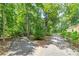 Split driveway near a yellow house with lush green trees at 590 Yancey Cir, Covington, GA 30014