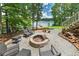 Outdoor fire pit seating area for relaxing, featuring a view of the lake in the background at 590 Yancey Cir, Covington, GA 30014