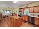 Country kitchen with an island, stainless steel appliances, and hardwood floors at 590 Yancey Cir, Covington, GA 30014