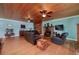 Inviting living room with a stone fireplace, warm wood ceiling, hardwood floors, and comfortable seating at 590 Yancey Cir, Covington, GA 30014