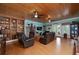 Cozy living room with a brick fireplace, hardwood floors, French doors, and custom built-ins at 590 Yancey Cir, Covington, GA 30014