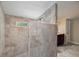 Walk-in shower with tan tile and a built-in bench at 590 Yancey Cir, Covington, GA 30014