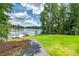 Beautiful waterfront lot with lush green grass, a dock, and boat perfect for enjoying the lake life at 590 Yancey Cir, Covington, GA 30014