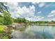 Beautiful waterfront property with dock and boat on a sunny day with fluffy white clouds at 590 Yancey Cir, Covington, GA 30014