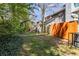 Spacious, grassy backyard bordered by a wood privacy fence and mature greenery for outdoor enjoyment at 732 Jamestown Xing, Jonesboro, GA 30238