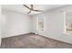 Bedroom featuring a ceiling fan, two windows with blinds, and neutral carpet at 732 Jamestown Xing, Jonesboro, GA 30238