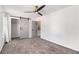 Bedroom featuring a ceiling fan, large closet with sliding barn door, and neutral carpet at 732 Jamestown Xing, Jonesboro, GA 30238