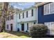 Attractive townhome with a light blue facade, complemented by lush greenery and a well-manicured lawn at 732 Jamestown Xing, Jonesboro, GA 30238