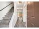 Welcoming foyer with a staircase, neutral walls, and modern gray wood flooring creating a bright and open space at 732 Jamestown Xing, Jonesboro, GA 30238