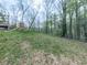 Sloped lawn with trees featuring play set at 841 Butterworth Rd, Canton, GA 30114