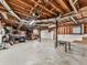 Unfinished basement with exposed ceiling and concrete floor provides ample storage or customization potential at 841 Butterworth Rd, Canton, GA 30114