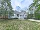 Serene home with natural landscaping, featuring a well-kept lawn, mature trees, and a private driveway at 841 Butterworth Rd, Canton, GA 30114