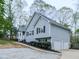 Charming gray home featuring a two-car garage, neatly trimmed bushes, and a well-maintained lawn and driveway at 841 Butterworth Rd, Canton, GA 30114