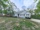 Inviting home with a manicured lawn, complemented by mature trees, tidy landscaping, and a welcoming entrance at 841 Butterworth Rd, Canton, GA 30114