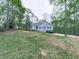 Peaceful home nestled among mature trees, featuring a well-maintained lawn and a private, secluded setting at 841 Butterworth Rd, Canton, GA 30114