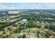 Expansive aerial view showcases home, landscaping, neighborhood, nearby Camp Branch Rd, and I-85 in Buford, Georgia at 2610 Ginger Dr, Buford, GA 30519