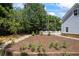 The serene backyard features a well-maintained garden and a charming white picket fence, ideal for outdoor enjoyment at 2610 Ginger Dr, Buford, GA 30519