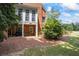 A backyard with a stone path leading to a covered patio, creating a cozy outdoor living space at 2610 Ginger Dr, Buford, GA 30519