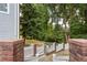 Backyard view with a white picket fence separating the yard from the woods at 2610 Ginger Dr, Buford, GA 30519