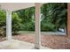 Secluded backyard with pebble ground cover and mature trees at 2610 Ginger Dr, Buford, GA 30519