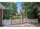 A basketball hoop in backyard featuring a pond and wrought iron fence at 2610 Ginger Dr, Buford, GA 30519