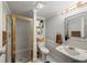 Bathroom featuring a glass-enclosed shower, a vintage sink and a decorative mirror at 2610 Ginger Dr, Buford, GA 30519