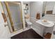 Nicely tiled bathroom featuring a glass shower, a pedestal sink and a decorative mirror at 2610 Ginger Dr, Buford, GA 30519