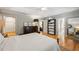 Neutral primary bedroom featuring tray ceiling, hardwood floors, large dresser and ensuite bath at 2610 Ginger Dr, Buford, GA 30519