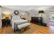 Bright primary bedroom with hardwood floors, a ceiling fan, and a neutral-toned decor at 2610 Ginger Dr, Buford, GA 30519