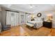 Light-filled bedroom featuring tray ceiling, ceiling fan, neutral tones and doors to the outside at 2610 Ginger Dr, Buford, GA 30519