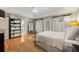 Spacious bedroom with large wardrobe, neutral tones, hardwood floors, and doors to the outside at 2610 Ginger Dr, Buford, GA 30519