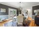 Warm dining area with hardwood floors, modern lighting, and views to adjacent rooms at 2610 Ginger Dr, Buford, GA 30519
