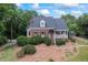 Charming brick home featuring a landscaped front yard and inviting front porch, perfect for relaxing outdoors at 2610 Ginger Dr, Buford, GA 30519