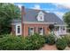 A charming brick home with lush landscaping, offers classic appeal with a welcoming front porch at 2610 Ginger Dr, Buford, GA 30519