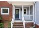 Charming front entrance with a glass paneled door, sidelight windows, and light blue siding at 2610 Ginger Dr, Buford, GA 30519