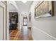 Hallway featuring hardwood floors, classic trim, and arched doorways, leading to various rooms in the home at 2610 Ginger Dr, Buford, GA 30519