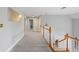 Well-lit hallway features light gray walls, crisp white trim, and a mix of carpet and wood flooring at 2610 Ginger Dr, Buford, GA 30519