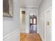 Hallway features elegant wainscoting, hardwood floors, and neutral wall paint, creating a bright and welcoming space at 2610 Ginger Dr, Buford, GA 30519