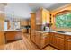 Bright kitchen with wood cabinetry, tile backsplash, and granite counters at 2610 Ginger Dr, Buford, GA 30519