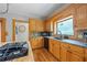 Kitchen features granite counters, tile backsplash, stainless sink, and wooden cabinetry at 2610 Ginger Dr, Buford, GA 30519