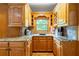 U-shaped kitchen with wooden cabinets, granite countertops, and stainless steel sink at 2610 Ginger Dr, Buford, GA 30519