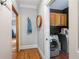 Hallway view of laundry room with gray paint and laundry machine at 2610 Ginger Dr, Buford, GA 30519