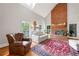 Bright living room with brick fireplace, tall ceilings, and large windows at 2610 Ginger Dr, Buford, GA 30519