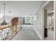 Spacious loft with a window, custom built-ins, and hardwood railing, next to a luxurious Primary bathroom at 2610 Ginger Dr, Buford, GA 30519