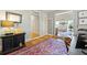 Home office with neutral walls, hardwood floors, and view into living room at 2610 Ginger Dr, Buford, GA 30519