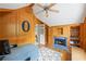 Warm wood-paneled office featuring a cozy fireplace, custom built-ins, and a large desk area at 2610 Ginger Dr, Buford, GA 30519