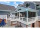 An outdoor patio featuring a screened in porch, overhead fan, and wrought iron furniture at 2610 Ginger Dr, Buford, GA 30519