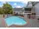 A swimming pool is surrounded by a gray deck, white fence and patio furniture at 2610 Ginger Dr, Buford, GA 30519